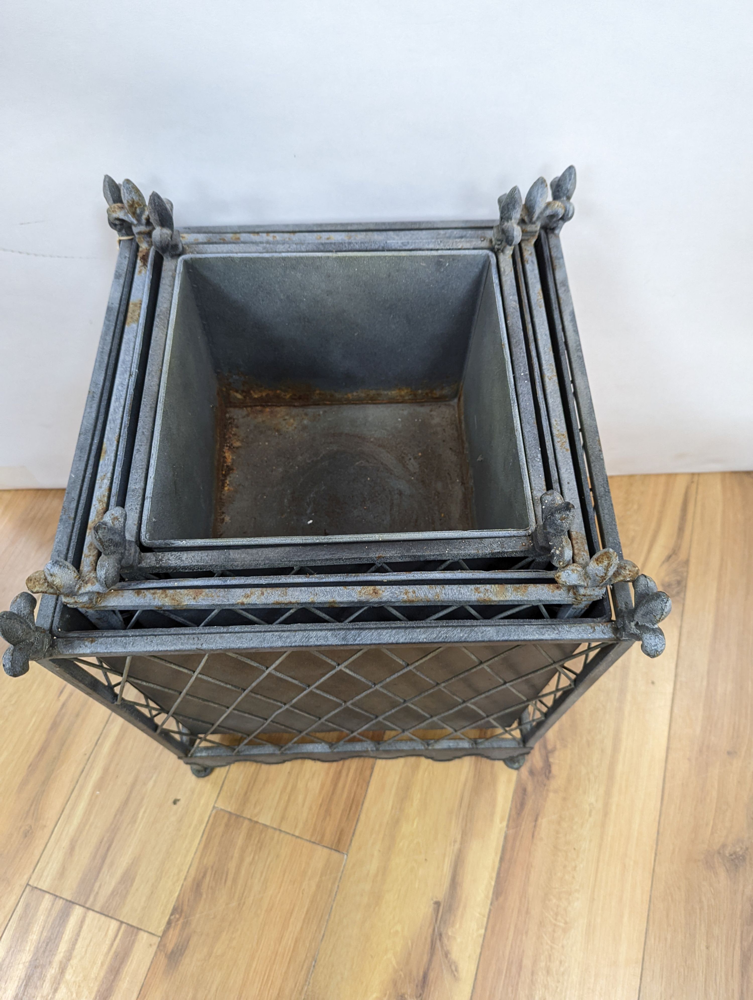 A graduated set of three zinc plated iron jardinieres, largest 41 cm wide, 51. 5 cm high